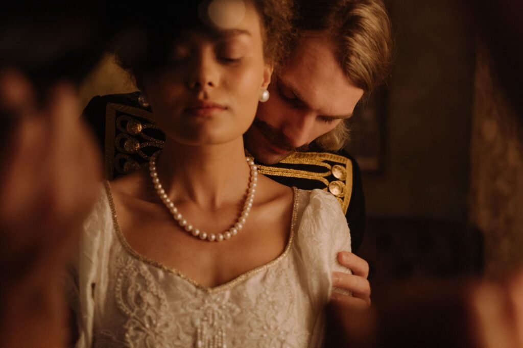 Intimate moment with a couple in period costume, exuding romance and elegance.